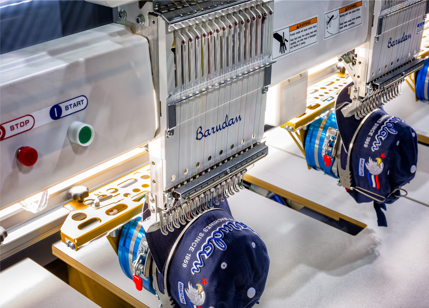 Multi-head embroidery machines stitching decorated caps